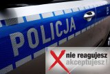 bok policyjnego radiowozu i logo kampanii &quot;Nie reagujesz - akceptujesz!&quot;