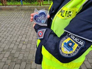 zbliżenie na trzymane przez policjantkę w ręce elementy odblaskowe