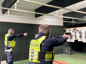 zdjęcie przedstawia policjantów strzelających na strzelnicy