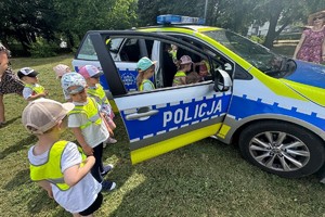 zdjęcie przedstawia policjanta z przedszkolakami