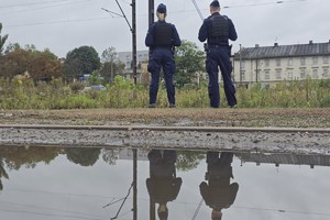 zdjęcie przedstawia policjantów obserwujących rejon torowiska