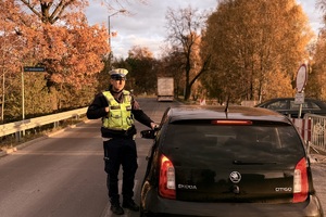 zdjęcie przedstawia policjantów w trakcie kontroli drogowej.