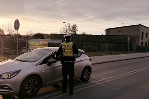 zdjęcie przedstawia policjantów w trakcie kontroli drogowej.
