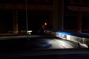 zdjęcie przedstawia policjanta w trakcie kontroli trzeźwości kierujących